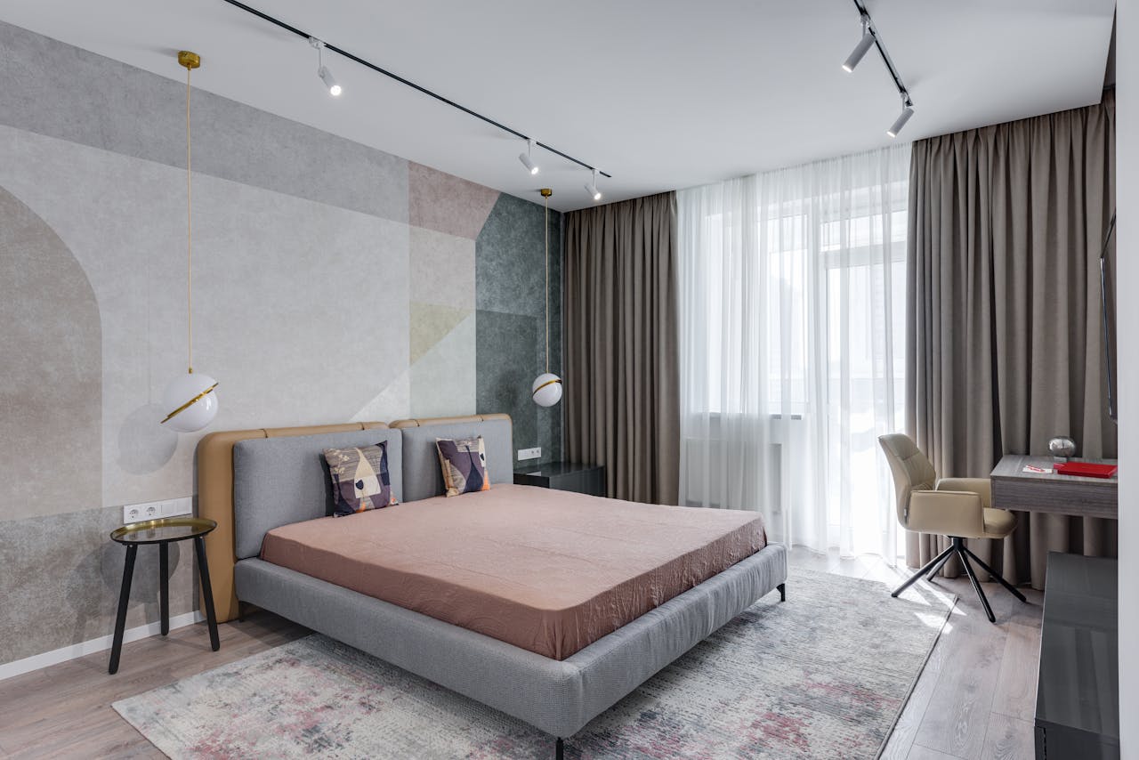 A chic and cozy modern bedroom featuring sleek furniture and contemporary design elements.